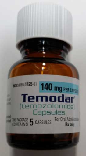 Bottles with cracked caps containing Temodar® (Temozolomide) and Temozolomide (generic) capsules - Image 1