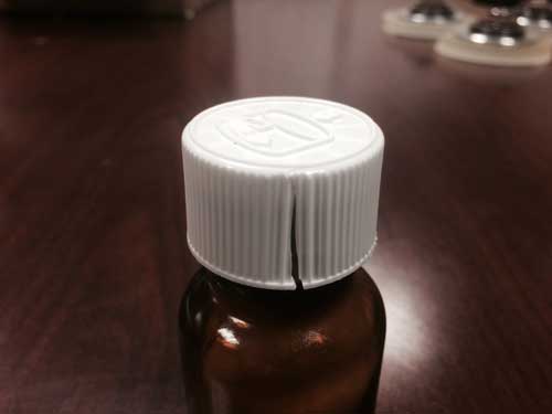 Bottles with cracked caps containing Temodar® (Temozolomide) and Temozolomide (generic) capsules - Image 3